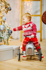 Happy fun child paying with little car at home on Christmas time. Xmas holiday concept