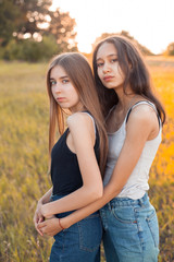 Fototapeta premium Portrait of two young women outdoors at sunset.