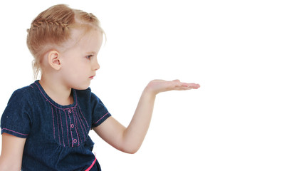 Little girl is showing a finger.The concept of advertising goods