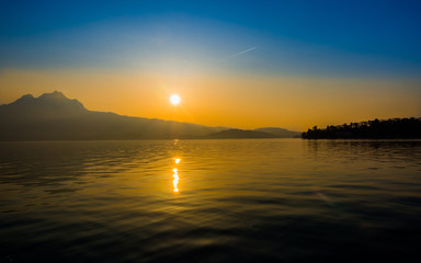 Sun reflection while setting over a lake
