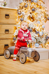 Happy fun child paying with little car at home on Christmas time. Xmas holiday concept