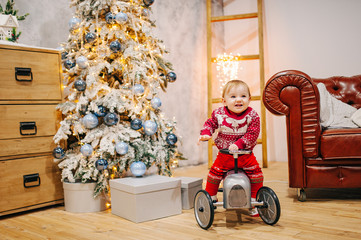 Happy fun child paying with little car at home on Christmas time. Xmas holiday concept