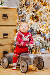 Happy fun child paying with little car at home on Christmas time. Xmas holiday concept