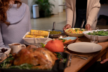 Millennial adult friends celebrating Thanksgiving together at home 