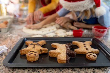 Family making Christmas cookies at home