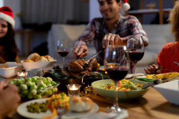 Millennial adult friends celebrating Christmas together at home 