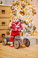 Happy fun child paying with little car at home on Christmas time. Xmas holiday concept