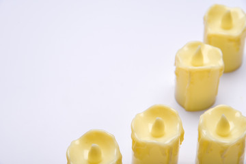 White candle on white background isolated. Set of  candle.Small candle with light yellow spots on light background. Christmas decor