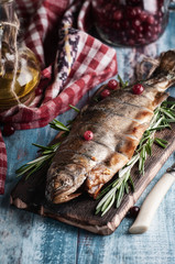 hot smoked fish, different options. on wooden board and wooden table