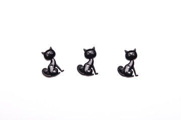 Naklejka premium Halloween decorations three black cat on white background , Halloween holiday background , top view