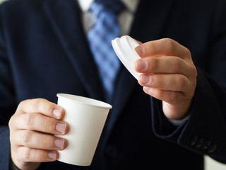 Close-up man holding little coffe cup mock-up