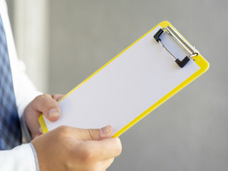 Close-up hand holding a clipboard mock-up