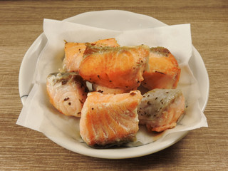 High angle view of a plate of delicious salmon on wooden background. Salmon is a popular seafood . With high protein, and high vitamin D content. Health food and fish concept.
