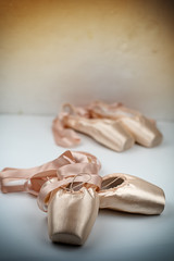 The pink satin ballet shoes put on white background,show detail,for practice
