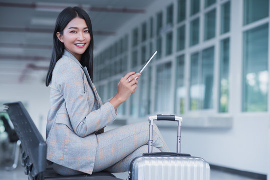 Happy Business Woman Working With Tablets, Beautiful Asian Women  In The Airport.