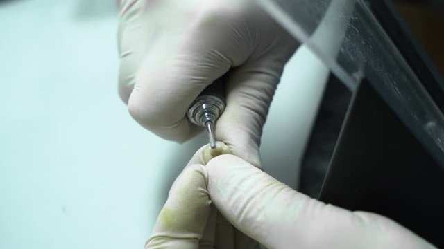 processing of dental crowns with a drill machine. laboratory. close-up