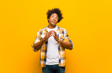 young black man scheming and conspiring, thinking devious tricks and cheats, cunning and betraying...