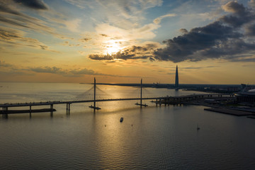 Fototapeta na wymiar Sunset sky aerial view of cable-stayed bridge and new skyscraper in St.Petersburg during sunset