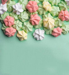 delicious colorful merengues, Trendy top view dessert image. Pink, green mint, yellow, white small homemade sweets