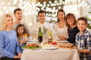 celebration, holidays and people concept - happy family having dinner party at home