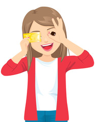 Young beautiful happy woman holding credit card smiling doing ok sign with hand on eye looking through fingers