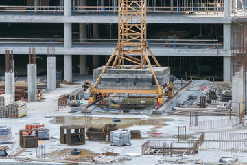 construction site with materials and crane, machinery. 