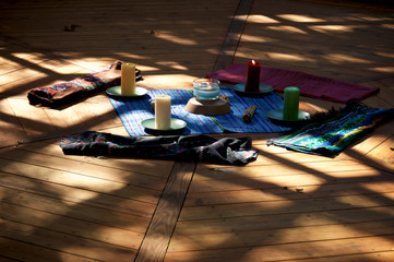 Center of pagan mayan ceremonial prayer space, with corn cobs, woven fabric and candles for the 5...