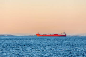 Freight ship on the ocean at sunset