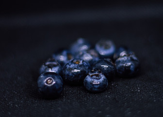 Some fresh and healthy blueberries on black background