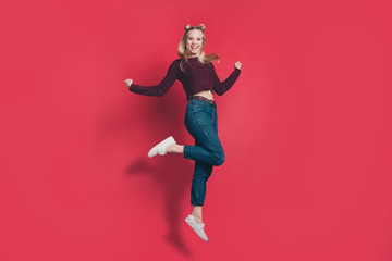 Full body profile photo of funny attractive lady jumping high rejoicing in flight wear knitted...