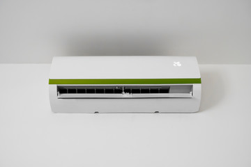 Air conditioner mounted on a white wall in the living room or bedroom. Indooor comfort temperature. Health concepts and energy savings.