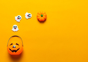 Halloween holiday concept, Spooky pumpkins and ghosts in orange background with copy space for text, Top flat view wallpaper