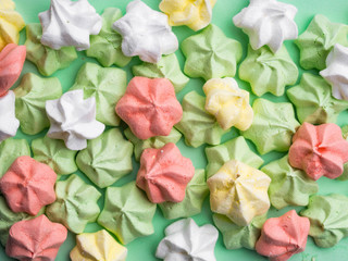 delicious colorful merengues, Trendy top view dessert image. Pink, green mint, yellow, white small homemade sweets