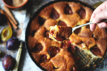 Selective focus. Slice of plum pie on a fork. Homemade American plum pie. Macro.