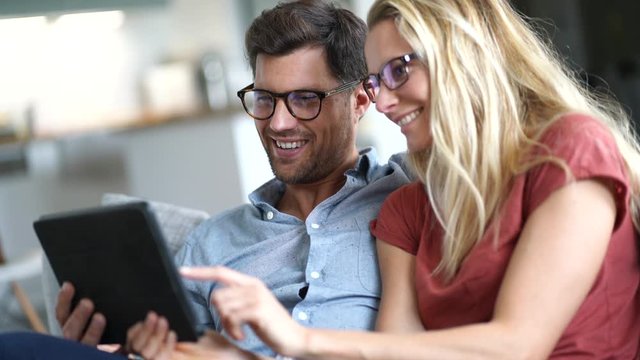 Young couple watching movie on digital tablet