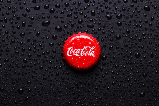  classic cap close-up of Coca-cola. Cap of cola on a black background with water drops.
