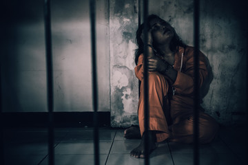 Portrait of women desperate to catch the iron prison,prisoner concept,thailand people,Hope to be...