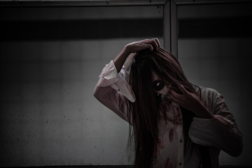 Portrait of asian woman make up ghost face with blood,Horror scene,Scary background,Halloween...