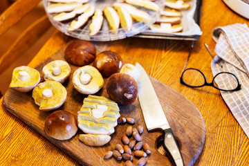 Mushroom Boletus - ECO autumn forest goodies in the kitchen. Sliced brown cap on the wooden board. Mushroom preparation for drying.