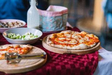 Buffet table with pizza on wooden tray