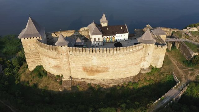 Aerial view of old castle near the River. Hotyn Castle in Ukraine. Eastern Europe. Tracking from left to right.