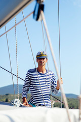 Handsome young man on a sailboat