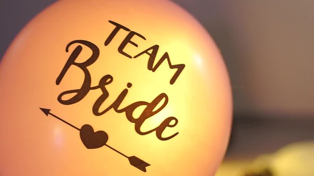 close-up of the lettering team bride, against the background high-heeled shoes