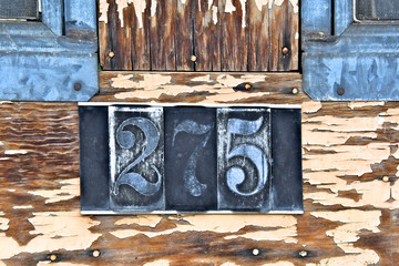 Faded house address from bygone era 