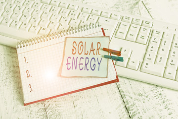 Conceptual hand writing showing Solar Energy. Concept meaning radiation from the Sun capable of producing heat or electricity notebook reminder clothespin with pinned sheet light wooden