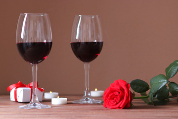 red wine and roses on the table. Valentine's day background. A gala dinner for two.