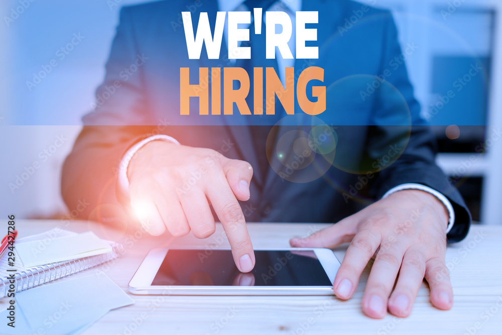 Poster handwriting text we are re hiring. conceptual photo process of reviewing applications and finding ca