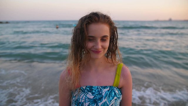 Portrait of Young Pretty Blonde  Woman at Sand Beach Coast with Tide Waves in Palma. Pretty Sun Kissed Wet haired Girl on Spanish Seaside. Carefee Traveller on Holiday Vacation.