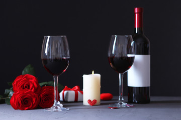 Fototapeta na wymiar red wine and roses on the table. Valentine's day background. A gala dinner for two.