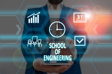 Obraz premium Text sign showing School Of Engineering. Business photo showcasing college to study mechanical communication subjects Male human wear formal work suit presenting presentation using smart device